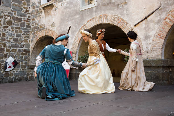 Medieval Damsels dancing in a historical Court Yard, Gorizia, Italy stock photo