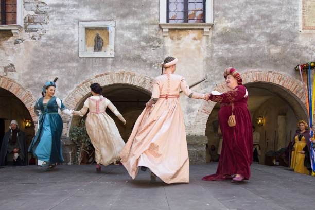 Medieval Damsels dancing in medieval clothes on Gorizia castle, Italy. Gorizia, Italy - April 23, 2017: Womans medieval historical dances in medieval clothes on historical reenactment in Gorizia castle, Gorizia, Italy. historical reenactment stock pictures, royalty-free photos & images