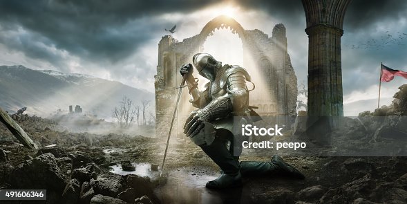 istock Medieval Knight Kneeling With Sword In Front of Building Ruin 491606346