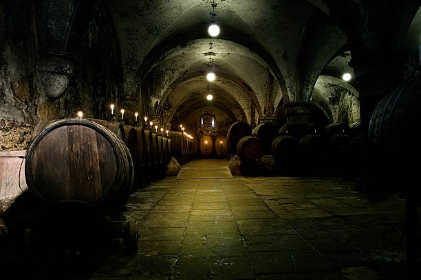 Medieval wine cellar - illuminated barrels Medieval wine cellar - illuminated barrels abbey monastery stock pictures, royalty-free photos & images