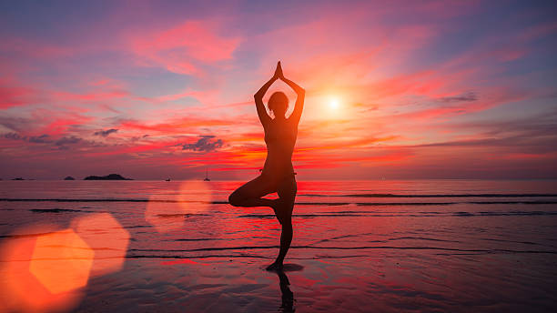 Meditation girl on the sea during sunset. stock photo