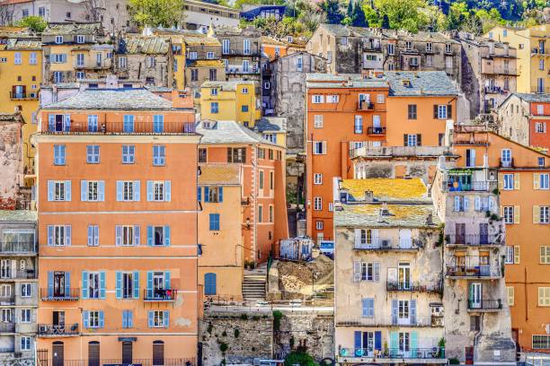 Mediterranean colorful facades in Basti, Corsica Charming atmosphere of the oldest part of the city of Bastia, with colored facades, stoned roofs, wooden shutters bastia stock pictures, royalty-free photos & images