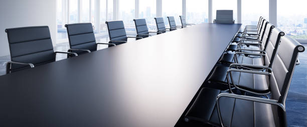 Meeting room in the office skyscraper Large conference table with chairs in a meeting room in the high-rise office building, view to the skyline conference table stock pictures, royalty-free photos & images