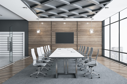 Meeting room interior with empty tv screen and panoramic city view with sunlight. 3D Rendering