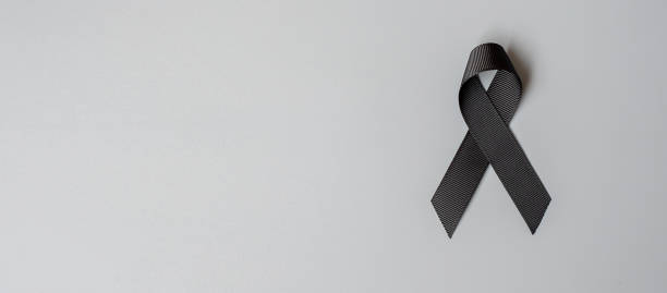 Melanoma and skin cancer, Vaccine injury awareness month and rest in peace concepts. black Ribbon on grey background stock photo