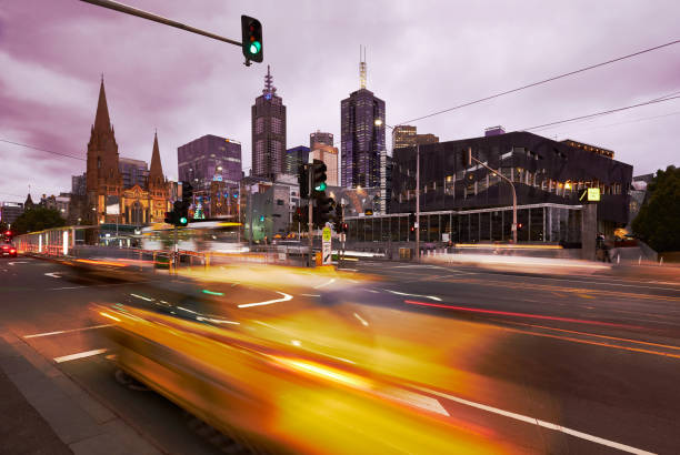 Melbourne downtown district. Melbourne downtown district.
Blurred taxi on the foreground. melbourne street stock pictures, royalty-free photos & images