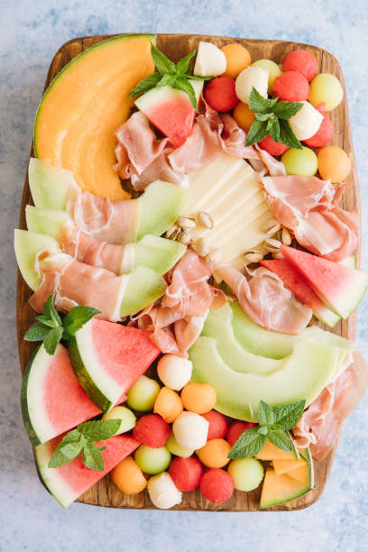 melon and cheese charcuterie board stock photo