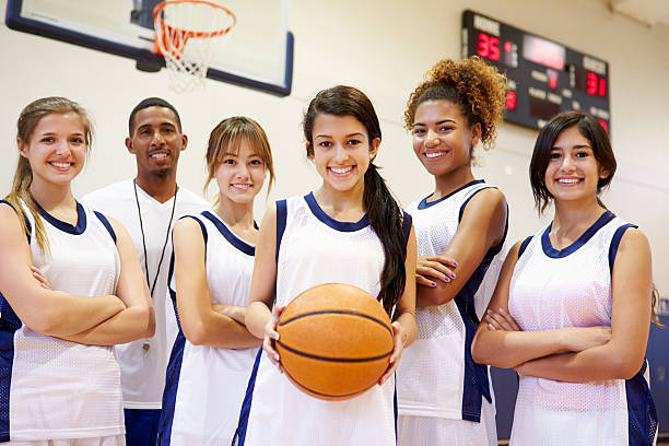members of female high school basketball team with coach - teen girls team sport bildbanksfoton och bilder