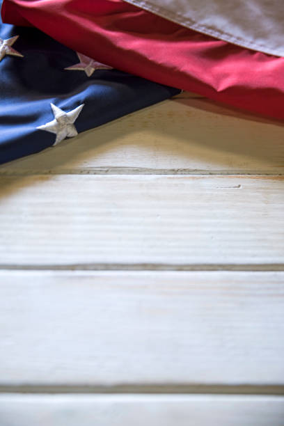 Memorial Day American Flag on White wooden Table This is a close up photo of an American flag on and old retro white wooden table. This is a great image for memorial day, Fourth of July, veterans Day, etc. memorial day background stock pictures, royalty-free photos & images