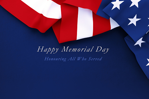Happy Memorial Day message written below rippled American flag over navy blue background. Horizontal composition with copy space. Directly above. Memorial Day concept.