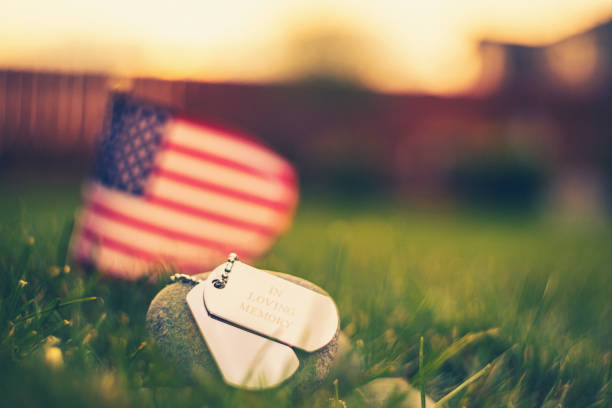 Memorial Day flag and dog tags in evening sunshine Memorial Day flag and dog tags in evening sunshine memorial day stock pictures, royalty-free photos & images