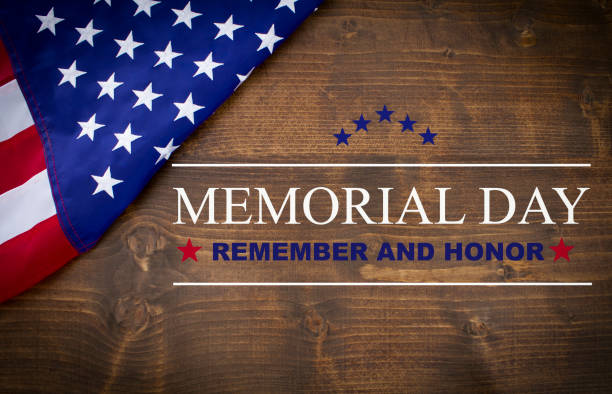 Memorial Day Memorial Day written on a dark wood background, with an American flag. memorial day background stock pictures, royalty-free photos & images