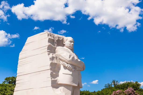 MLK Memorial Washington DC, USA - June 2017: The Martin Luther King Jr memorial sculpture stands tall on a sunny blue sky day. martin luther king jr photos stock pictures, royalty-free photos & images