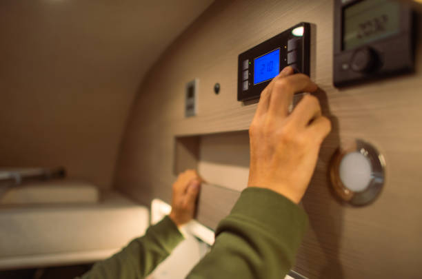 Men Adjusting Interior RV Camper Van Temperature stock photo