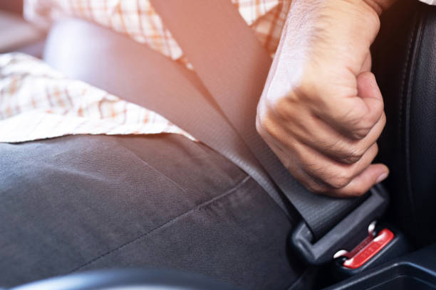Men are wearing seat belts every time before driving. For safety Men are wearing seat belts every time before driving. For safety seat belt stock pictures, royalty-free photos & images