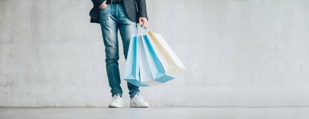 men fashion clothing store guy smart casual outfit Men fashion clothing store. Advertisement promotion. Guy in smart casual outfit holding paper bags. men's fashion stock pictures, royalty-free photos & images