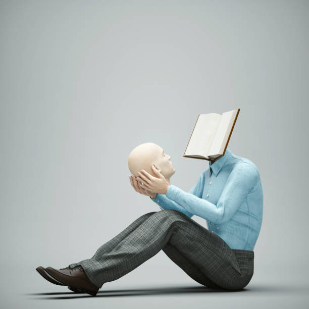 Men holding a head in his hands with an opened book. stock photo