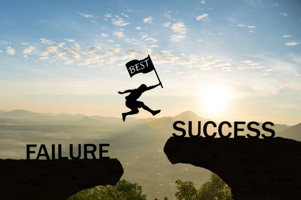 Men jump over silhouette hand hold flag best failure Committed to success. stock photo