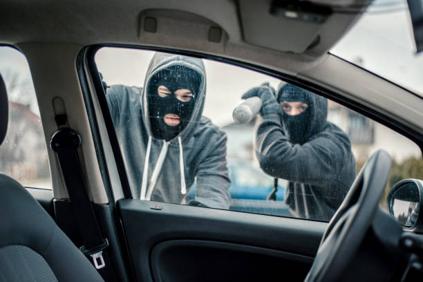 Men stealing a car Men stealing a car vandalism stock pictures, royalty-free photos & images