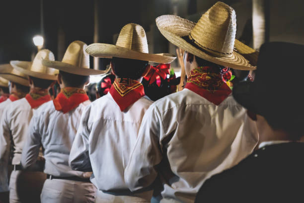 Men with traditional Mexican clothing and straw hats lining up before performance, Merida, Mexico stock photo