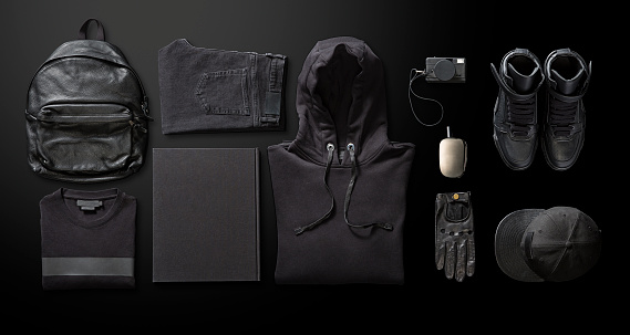 Men’s clothing with personal accesorries on black background
