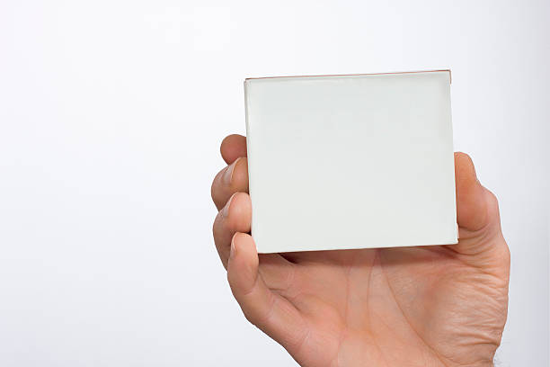 Men's hand with a white packet in a white background stock photo