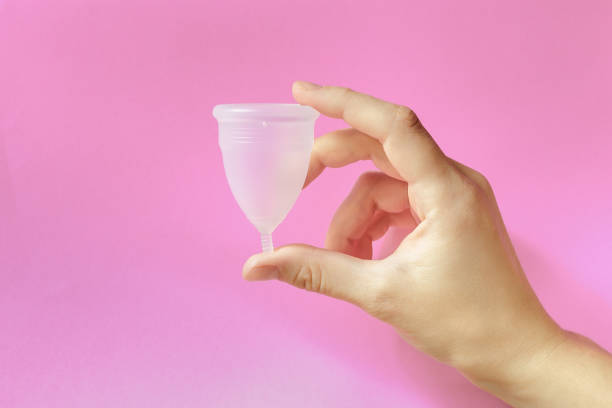 Menstrual cup on pink background, feminine hygiene stock photo