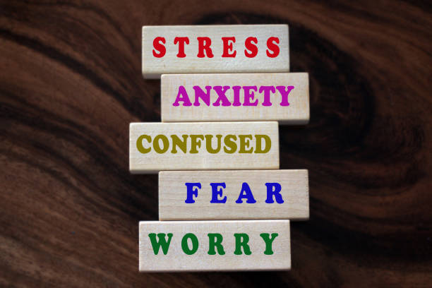 Mental health awarness concept with single words printed on wooden blocks - stress, anxiety, confused, fear, worry and all negativity. Colorful negative single word list on wooden blocks. Master your mind concept from stress, anxiety, confused, fear, worry and negativity. Mental health awareness concept. mental health awareness stock pictures, royalty-free photos & images