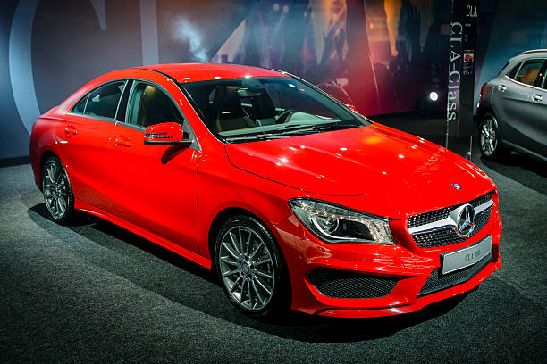 Mercedes Benz CLA Brussels, Belgium - January 14, 2014: Red Mercedes Benz CLA compact saloon car on display at the 2014 Brussels motor show. mercedes benz stock pictures, royalty-free photos & images