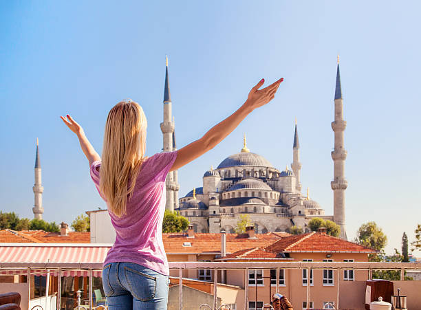 Merhaba, Istanbul! Girl welcomes the Blue mosque in Istanbul. stock photo