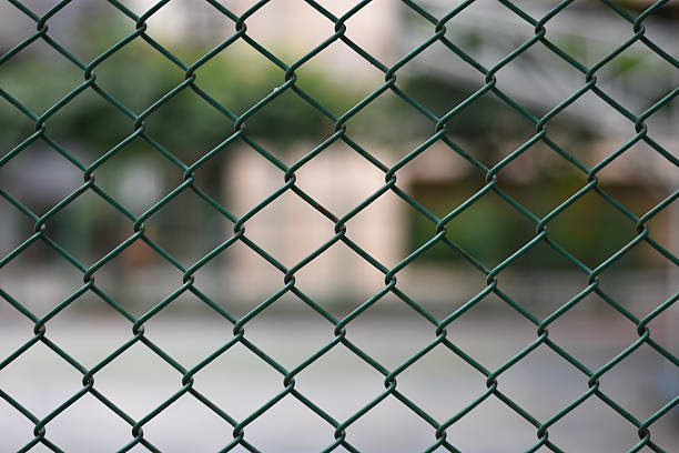 Mesh fence panel on blurred Background Mesh fence panel on blurred Background linkage effect stock pictures, royalty-free photos & images