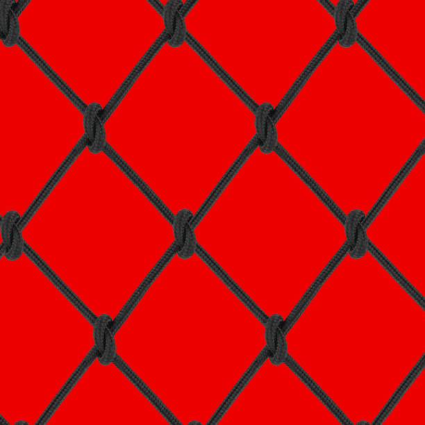 mesh of black braided rope on a red background stock photo