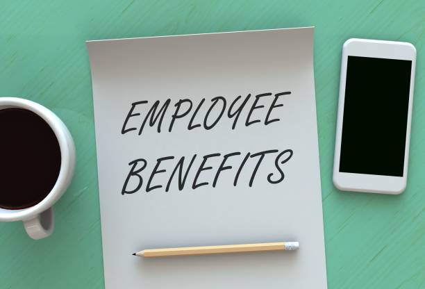 EMPLOYEE BENEFITS, message on paper, smart phone and coffee on table stock photo