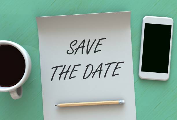 SAVE THE DATE, message on paper, smart phone and coffee on table stock photo