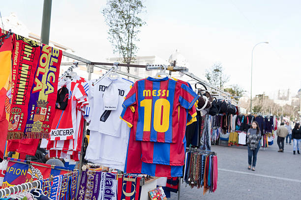 Messi tshirt "Madrid, Spain - February 26, 2011: street market selling tshirts and scarfs from football teams mainly Real Madrid and Barcelona F.C." la liga stock pictures, royalty-free photos & images