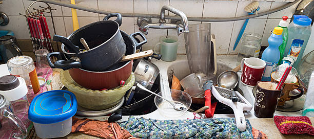 Messy Dirty Kitchen Pile of dirty utensils in a kitchen washbasin unhygienic stock pictures, royalty-free photos & images