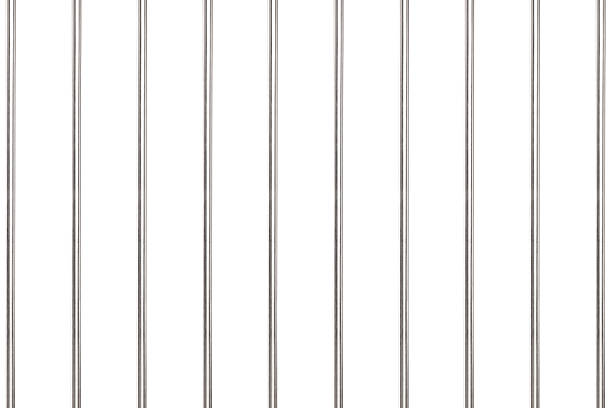 Metal bars in prison A studio shot of metal bars in prison isolated on white background pole stock pictures, royalty-free photos & images