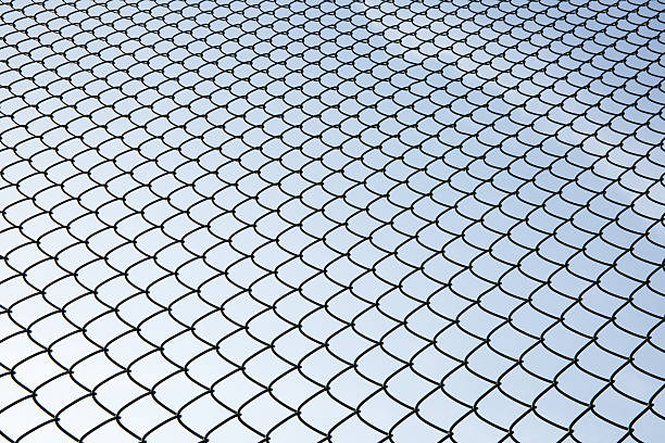 Metal Mesh and sky Metal Mesh and sky, low angle view. It looks like fish scales. linkage effect stock pictures, royalty-free photos & images