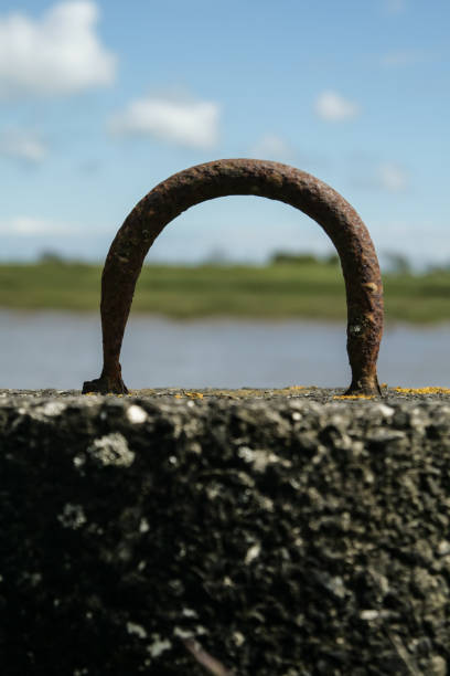 Metal mooring hoop by a lake stock photo