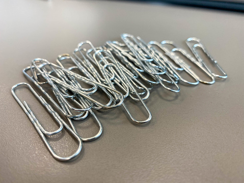 Metal paper clips . The idea for the design of school notebooks.