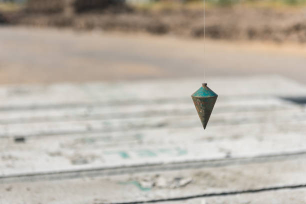 metal plumb line used in construction site stock photo