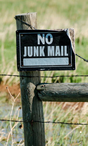 Metal sign on wooden fence warning no junk mail stock photo
