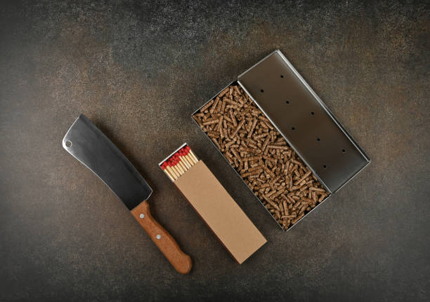 Metal smoker box, matches and meat cleaver stock photo