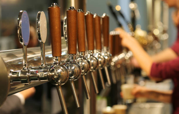 metal taps with the wooden handle for draft beer stock photo
