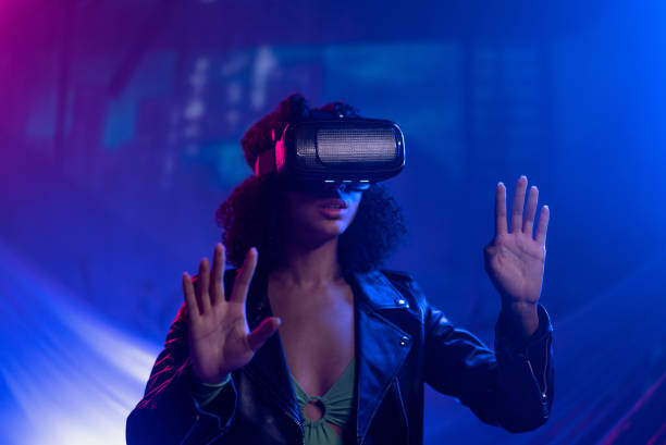 Metaverse digital cyber world technology, woman with virtual reality VR goggles playing augmented reality game, futuristic lifestyle stock photo