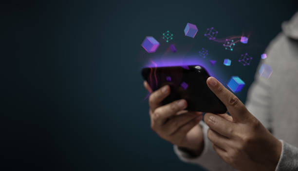 Metaverse, Web3 and Blockchain Technology Concepts. Closeup of Hand Using Smartphone for Connect a Community or Playing NFT Virtual Game stock photo