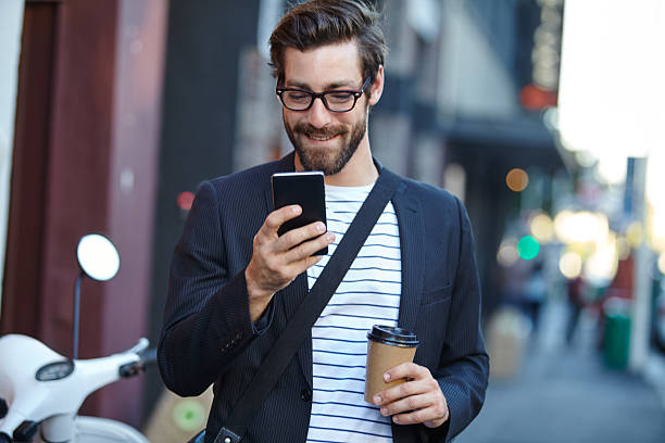 metro messaging on the move - walking with coffee stockfoto's en -beelden