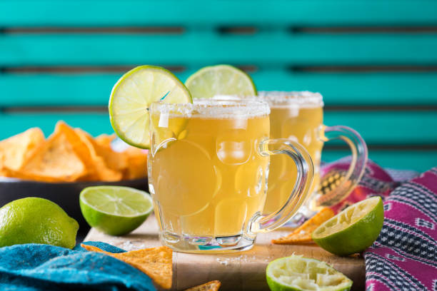 Mexican alcohol cocktail chelada with light beer and lime juice stock photo
