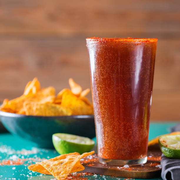 Mexican alcohol cocktail michelada with dark beer and lime juice stock photo