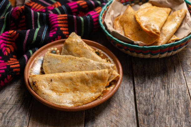 Mexican basket tacos also called "de canasta" on wooden background stock photo